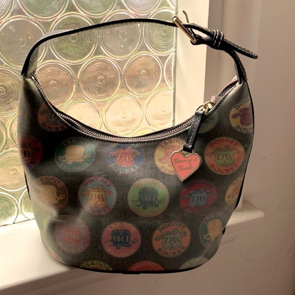 Authentic Dooney and Bourke wax coated handbag with adjustable leather strap